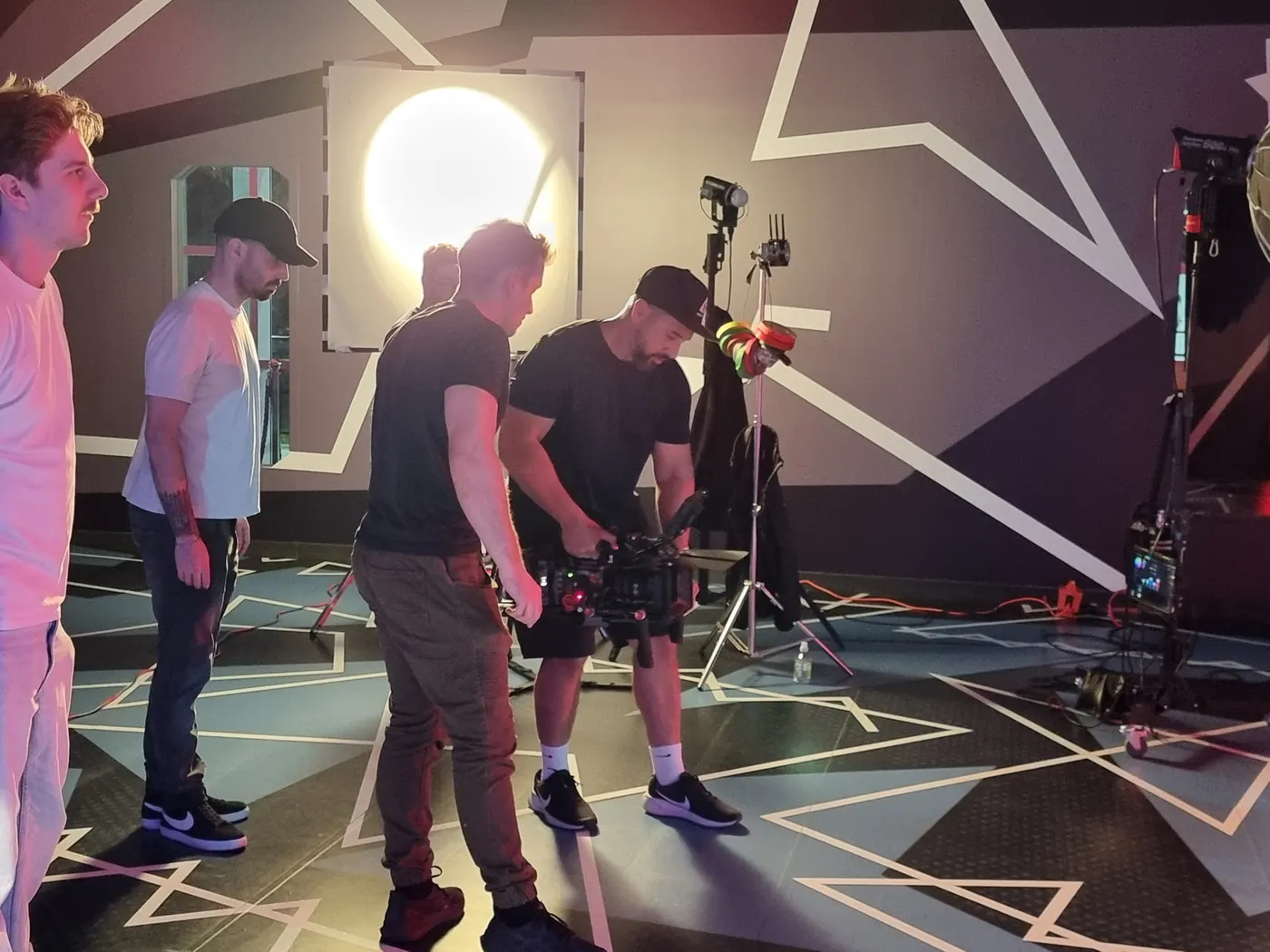 Camera rehearsal on a set painted with white geometric lines